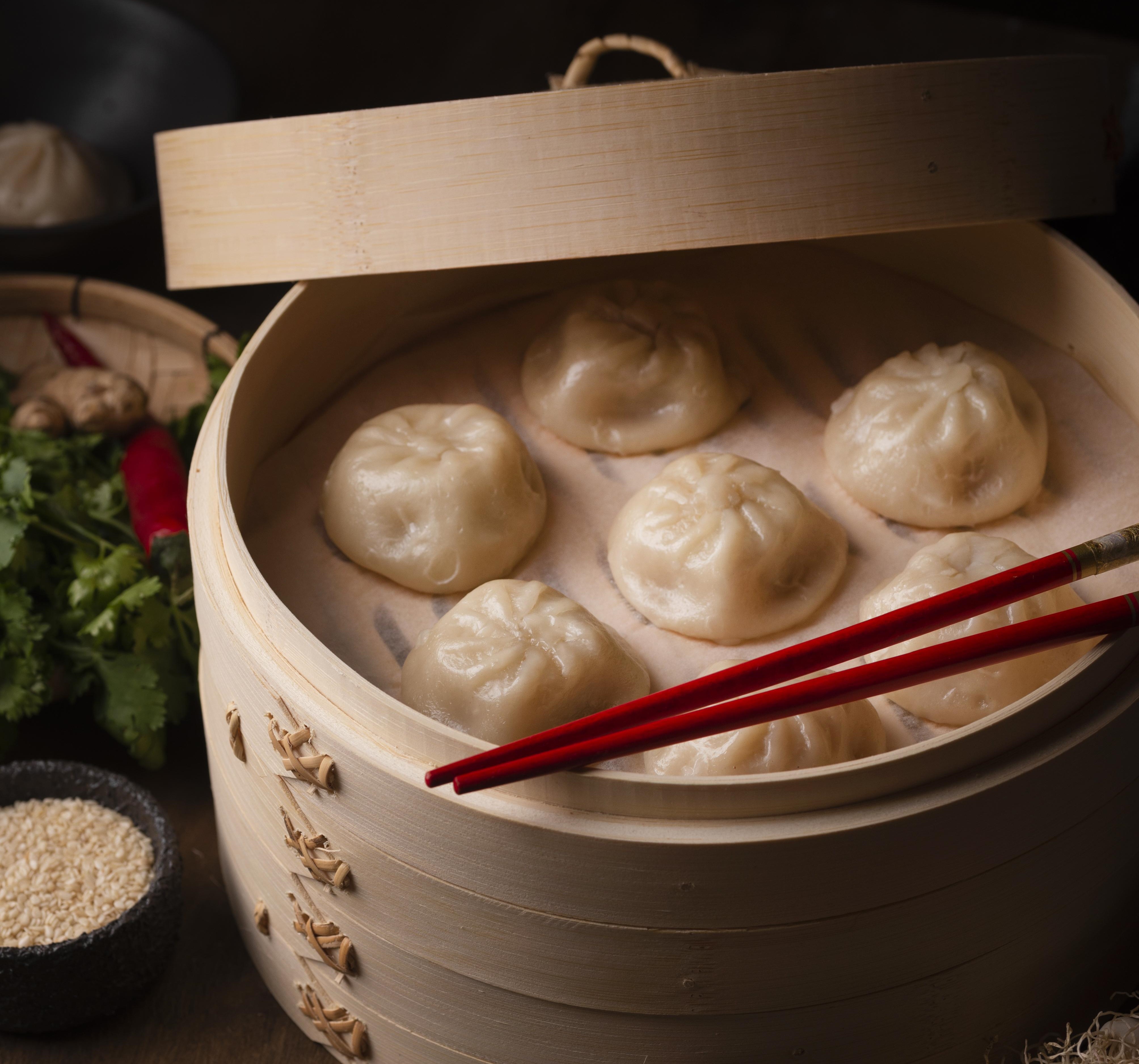 high angle traditional asian dumplings with chopsticks