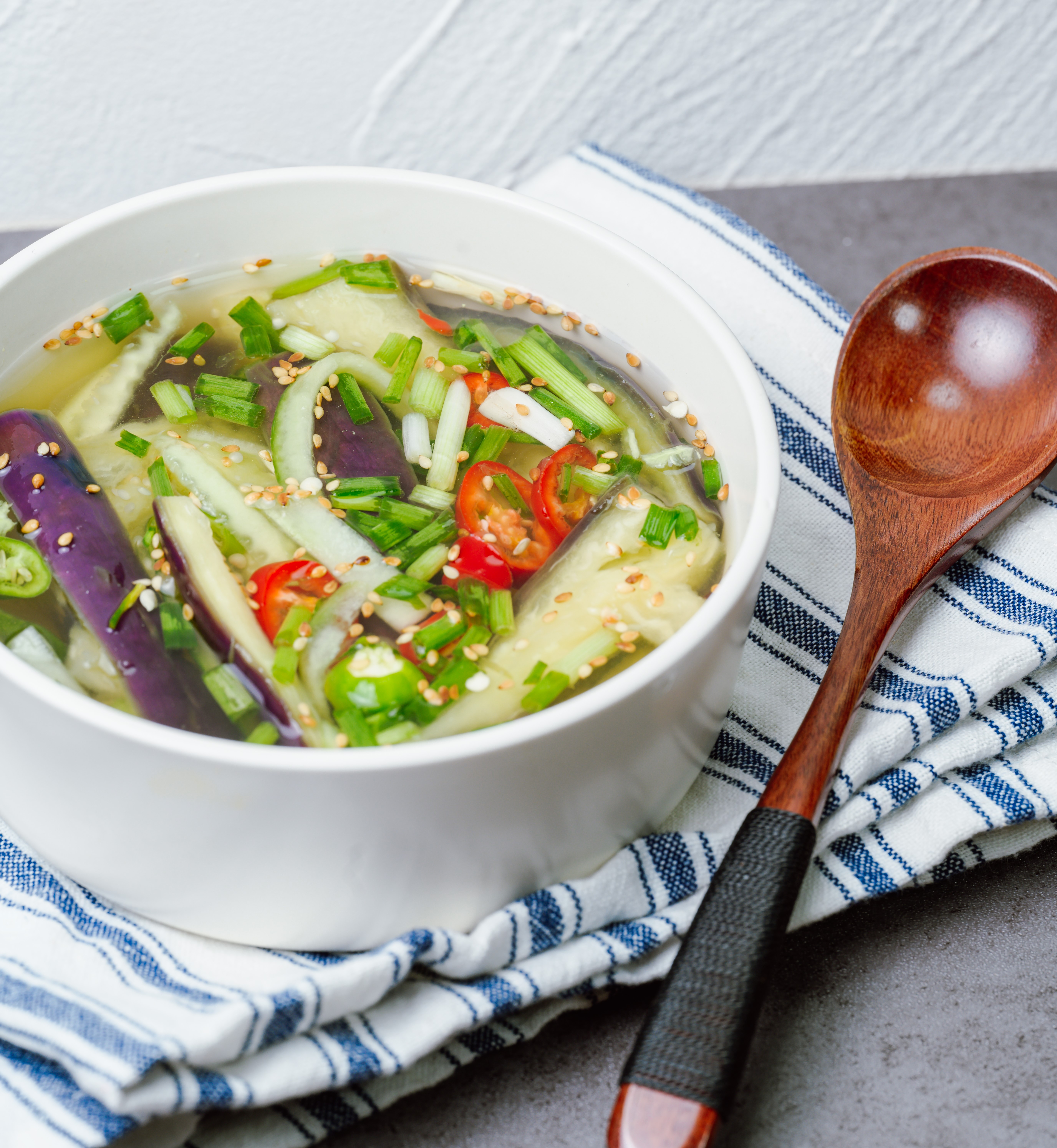 Oinaengguk, Korean Chilled Cucumber Soup, prepared with julienned, seasoned cucumber in a cool broth made with soy sauce, garlic, and vinegar. It is a popular summer dish.