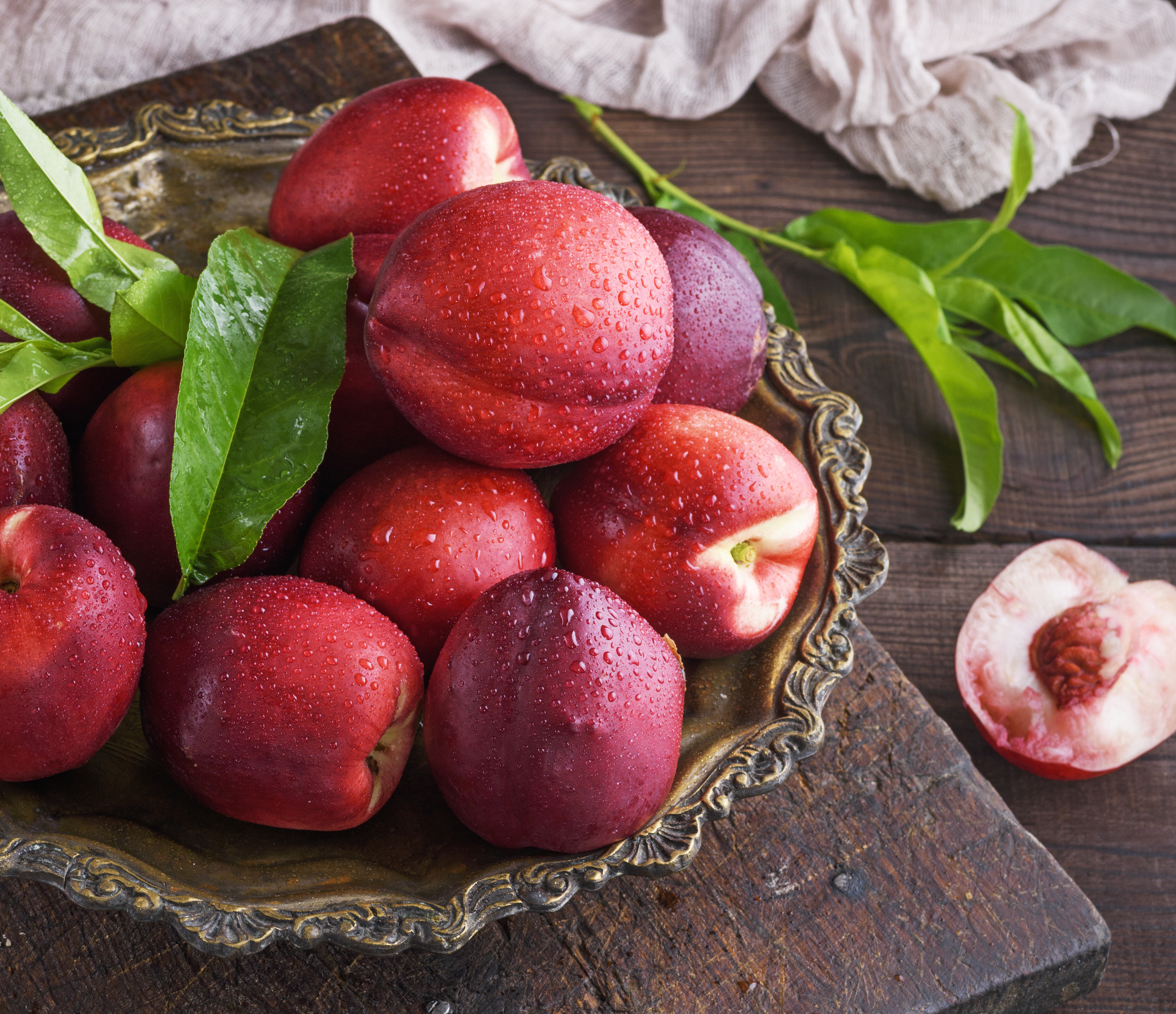 red ripe peaches nectarine in an iron plate, close up