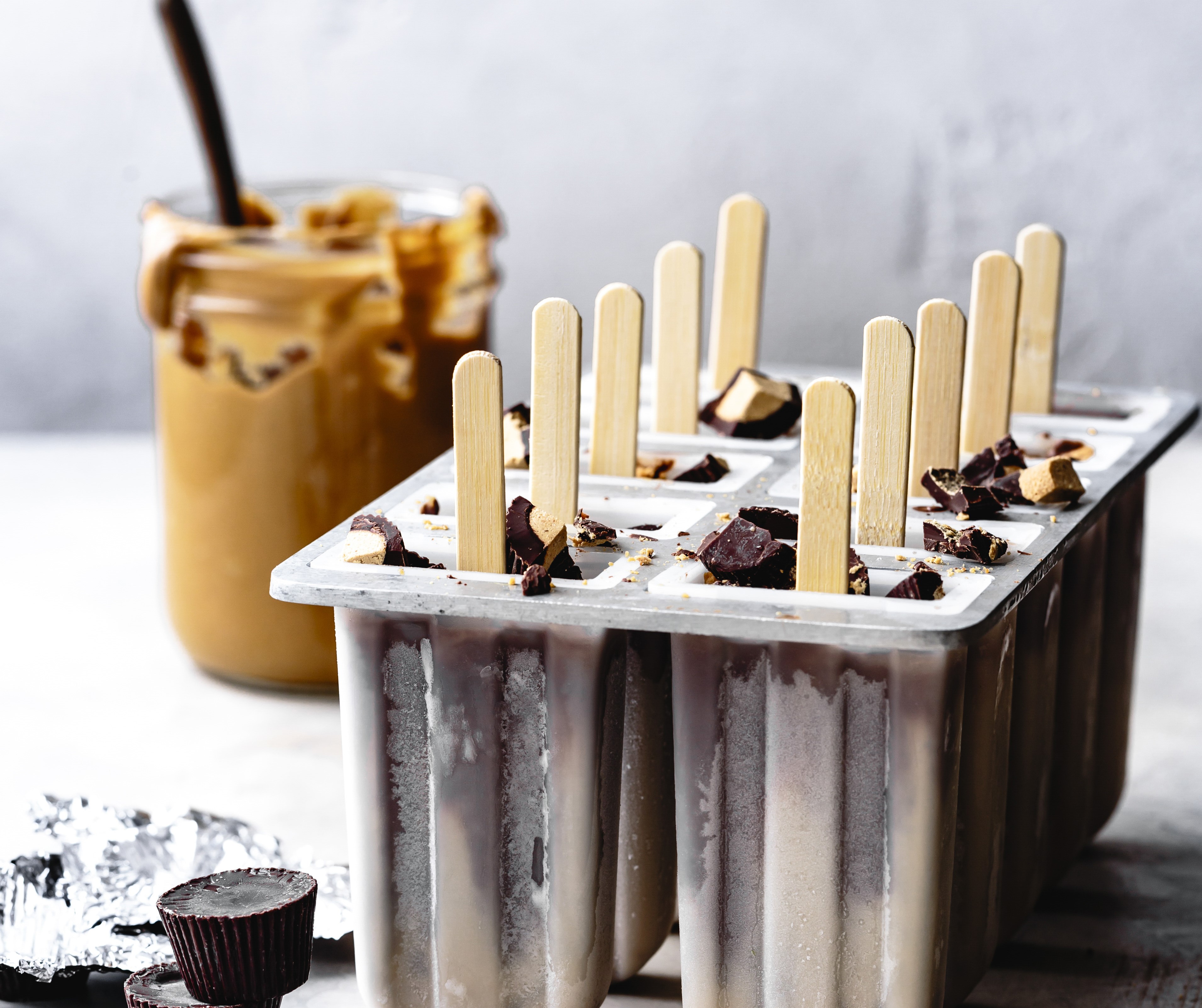 Peanut butter and chocolate fudge popsicles in a plastic mould.