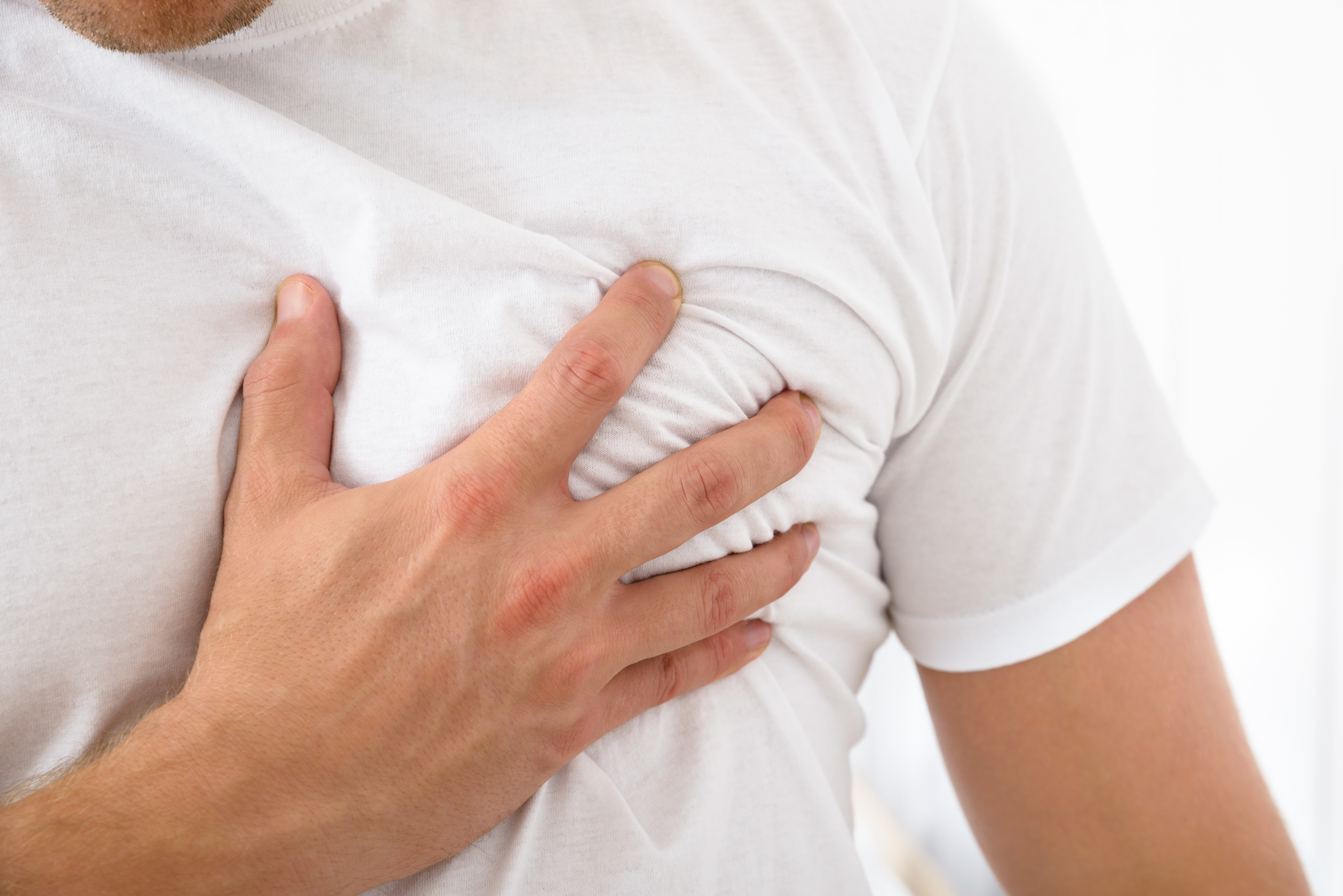 Close-up Of A Man Suffering From Chest Pain